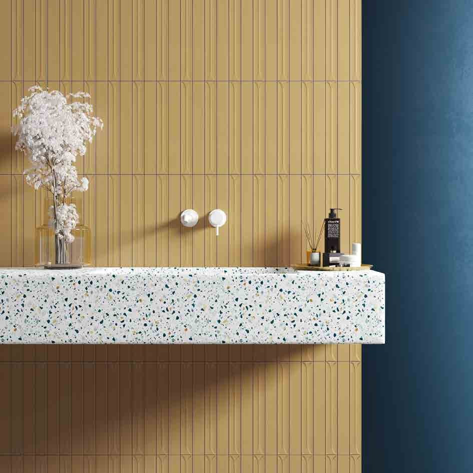 Mingle Golden Ceramic Wall Tile behind a terrazzo vanity